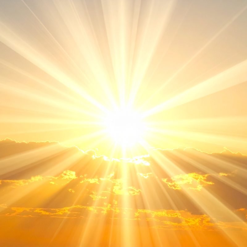 The sun breaking through cloud, its rays spread wide